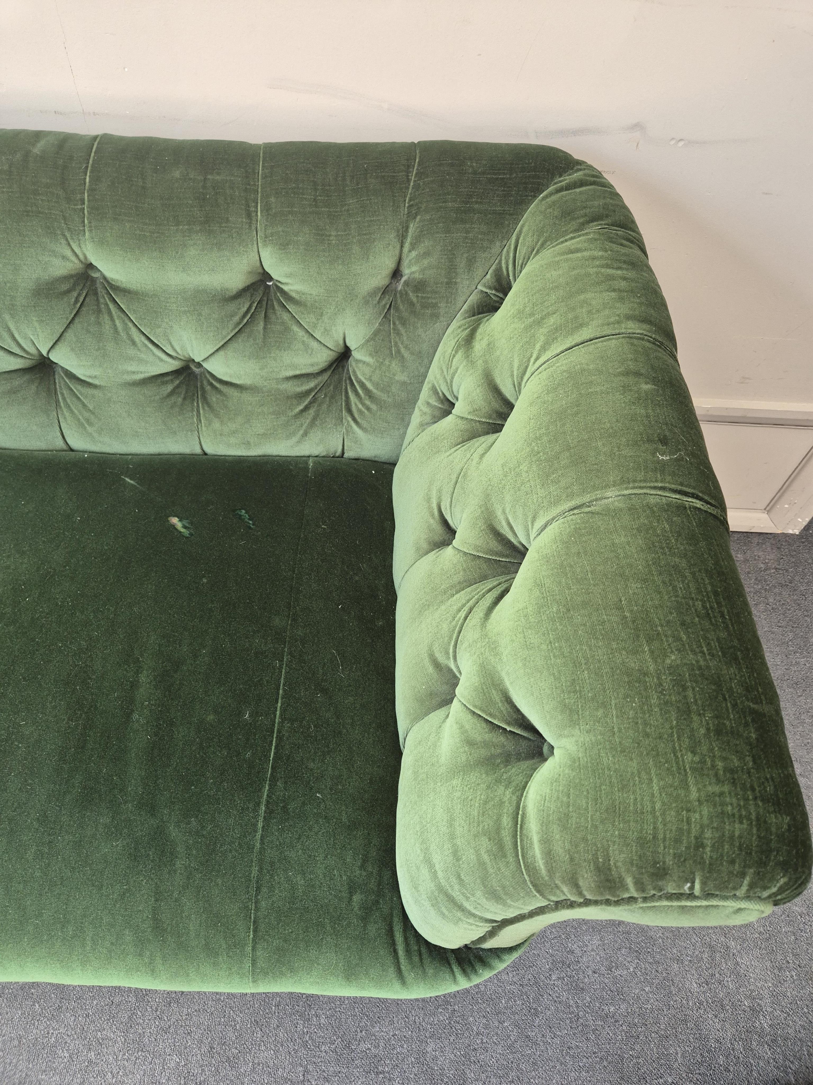 A Victorian mahogany settee upholstered in deep buttoned green velvet, width 210cm, depth 80cm, height 74cm. Condition - fair